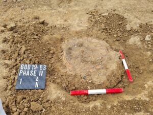 Urn pre excavation with site board and two scales