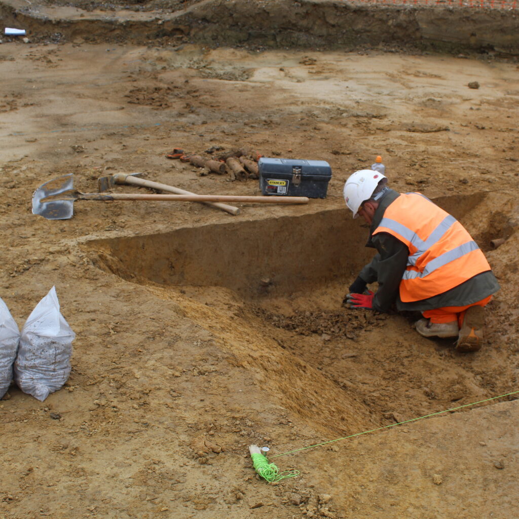 archaeologist_excavating_a_ditch_slot Archaeologist excavating a ditch slot